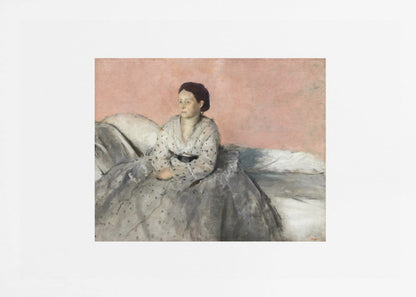 A framed impressionist painting of a woman with dark hair sitting on a bed against a dusty rose background. She wears a white, dotted blouse and a voluminous gray skirt, looking thoughtfully to her left. The painting is set in a silver frame with a white mat. Poster