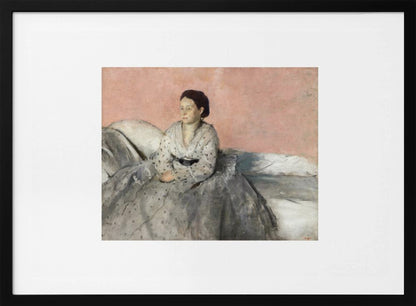 A framed impressionist painting of a woman with dark hair sitting on a bed against a dusty rose background. She wears a white, dotted blouse and a voluminous gray skirt, looking thoughtfully to her left. The painting is set in a silver frame with a white mat. Poster