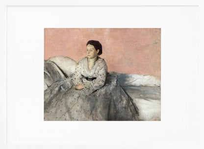 A framed impressionist painting of a woman with dark hair sitting on a bed against a dusty rose background. She wears a white, dotted blouse and a voluminous gray skirt, looking thoughtfully to her left. The painting is set in a silver frame with a white mat. Poster
