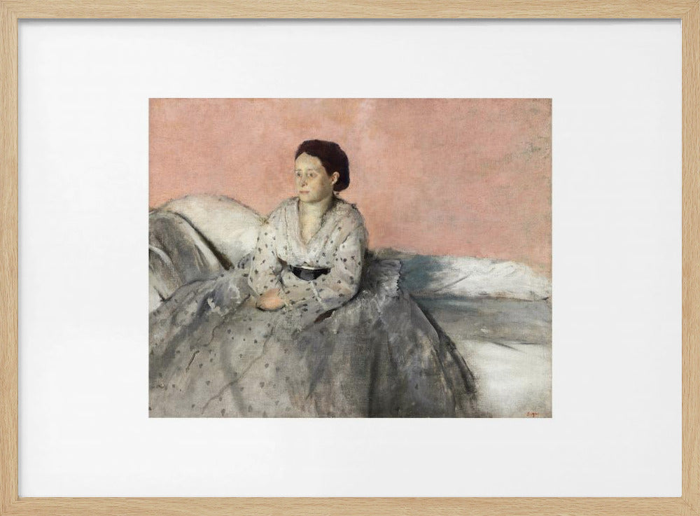 A framed impressionist painting of a woman with dark hair sitting on a bed against a dusty rose background. She wears a white, dotted blouse and a voluminous gray skirt, looking thoughtfully to her left. The painting is set in a silver frame with a white mat. Poster