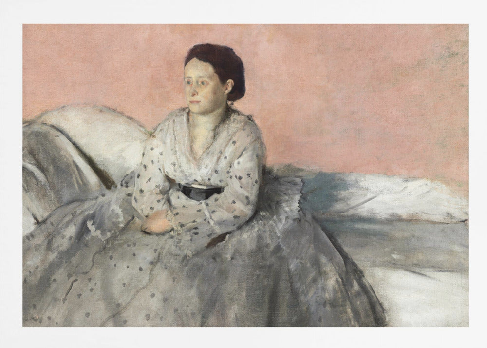 A framed impressionist painting titled 'Mélancolie' by Edgar Degas, depicting a woman with dark hair pulled back, seated on a couch or bed. She wears a white and grey polka-dotted dress with a black sash and has a pensive expression, looking off to the side against a soft pink background. Decor