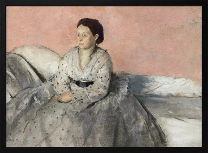 A framed impressionist painting titled 'Mélancolie' by Edgar Degas, depicting a woman with dark hair pulled back, seated on a couch or bed. She wears a white and grey polka-dotted dress with a black sash and has a pensive expression, looking off to the side against a soft pink background. Decor