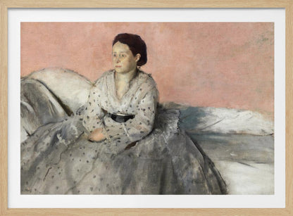 A framed impressionist painting titled 'Mélancolie' by Edgar Degas, depicting a woman with dark hair pulled back, seated on a couch or bed. She wears a white and grey polka-dotted dress with a black sash and has a pensive expression, looking off to the side against a soft pink background. Decor