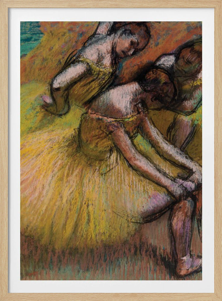 An impressionist pastel drawing of three ballet dancers in yellow tutus. One dancer is in the foreground, bent over to adjust her shoe, while two others are in the background. The artwork features a warm color palette with energetic, visible strokes. Decor