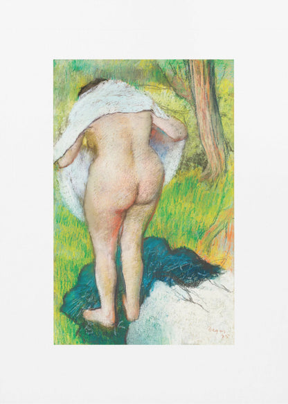 A framed pastel artwork by Edgar Degas showing the back of a nude woman as she dries herself with a white towel in a lush green landscape. The impressionist style is evident in the soft, textured application of color. Artwork
