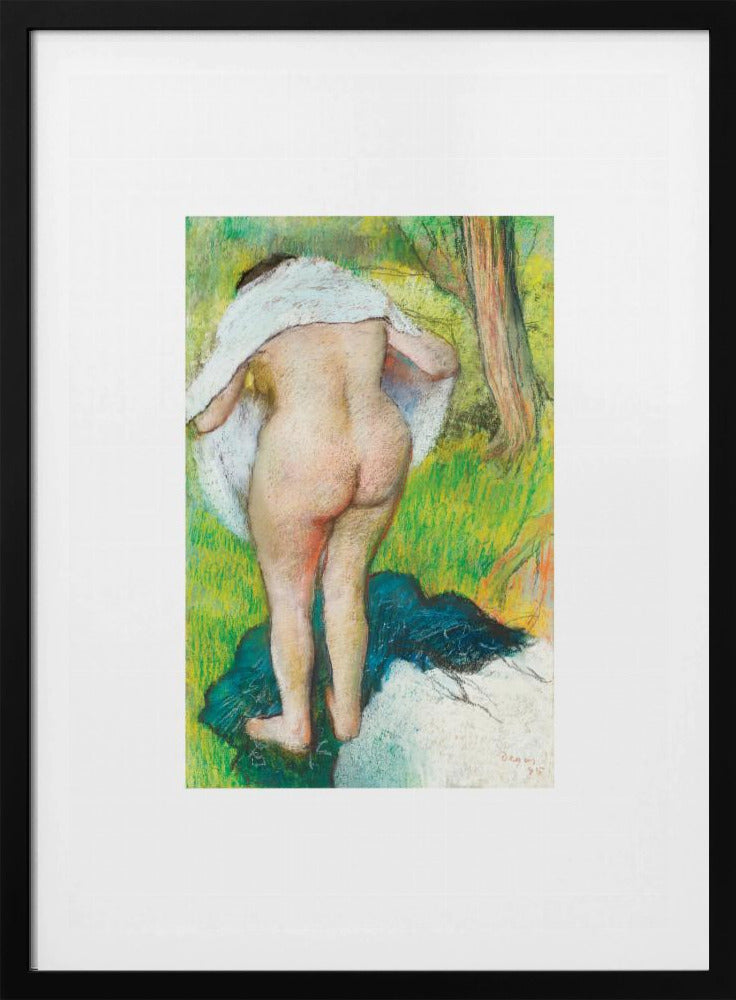 A framed pastel artwork by Edgar Degas showing the back of a nude woman as she dries herself with a white towel in a lush green landscape. The impressionist style is evident in the soft, textured application of color. Artwork
