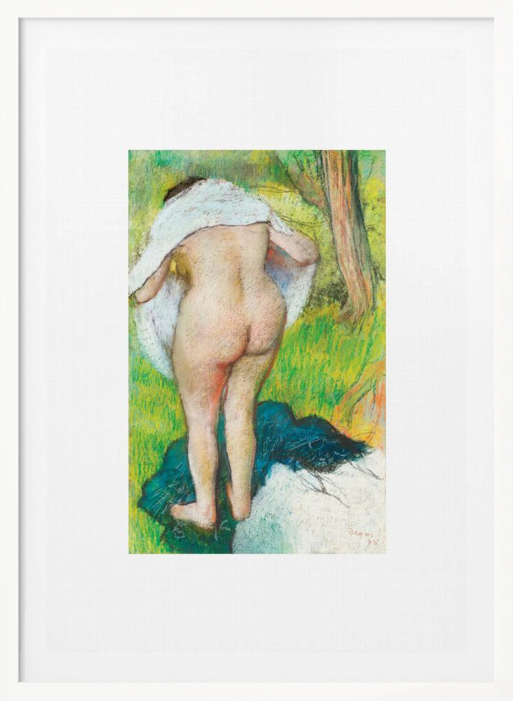 A framed pastel artwork by Edgar Degas showing the back of a nude woman as she dries herself with a white towel in a lush green landscape. The impressionist style is evident in the soft, textured application of color. Artwork
