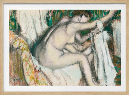 A framed pastel drawing by Edgar Degas depicting a nude woman from the back, seated on a patterned chair. Her body is rendered in soft yellow and grey tones, while she interacts with white drapery against a background of energetic green and brown strokes. Print