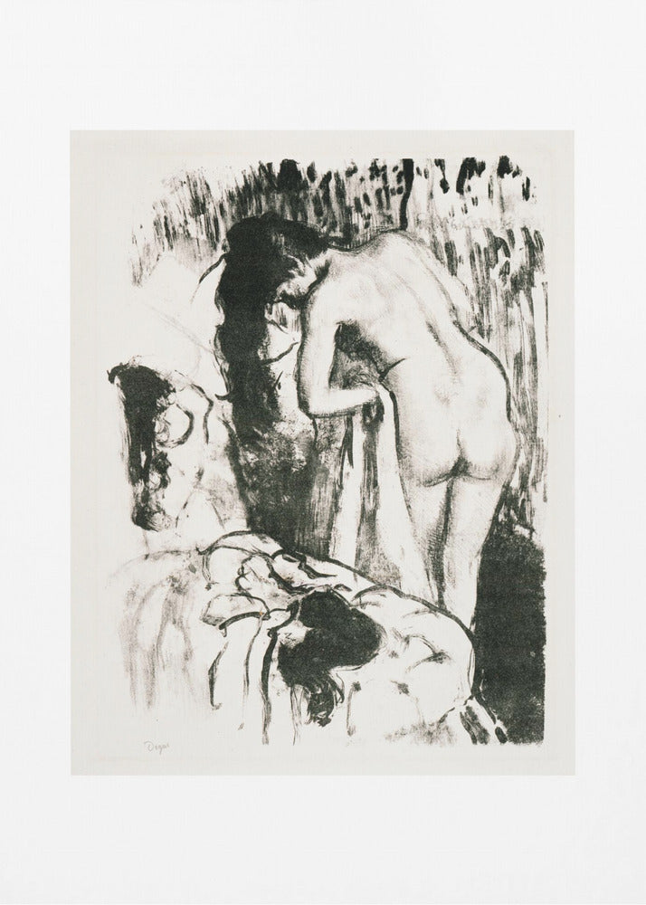 A framed black and white lithograph by Edgar Degas of a nude woman with long dark hair, viewed from the back as she leans over. The artwork has a sketchy, impressionistic style, capturing an intimate moment. Wall Art