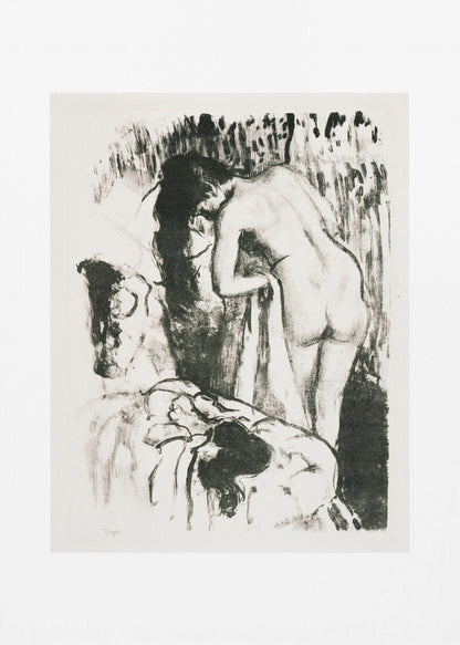 A framed black and white lithograph by Edgar Degas of a nude woman with long dark hair, viewed from the back as she leans over. The artwork has a sketchy, impressionistic style, capturing an intimate moment. Wall Art