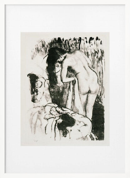 A framed black and white lithograph by Edgar Degas of a nude woman with long dark hair, viewed from the back as she leans over. The artwork has a sketchy, impressionistic style, capturing an intimate moment. Wall Art