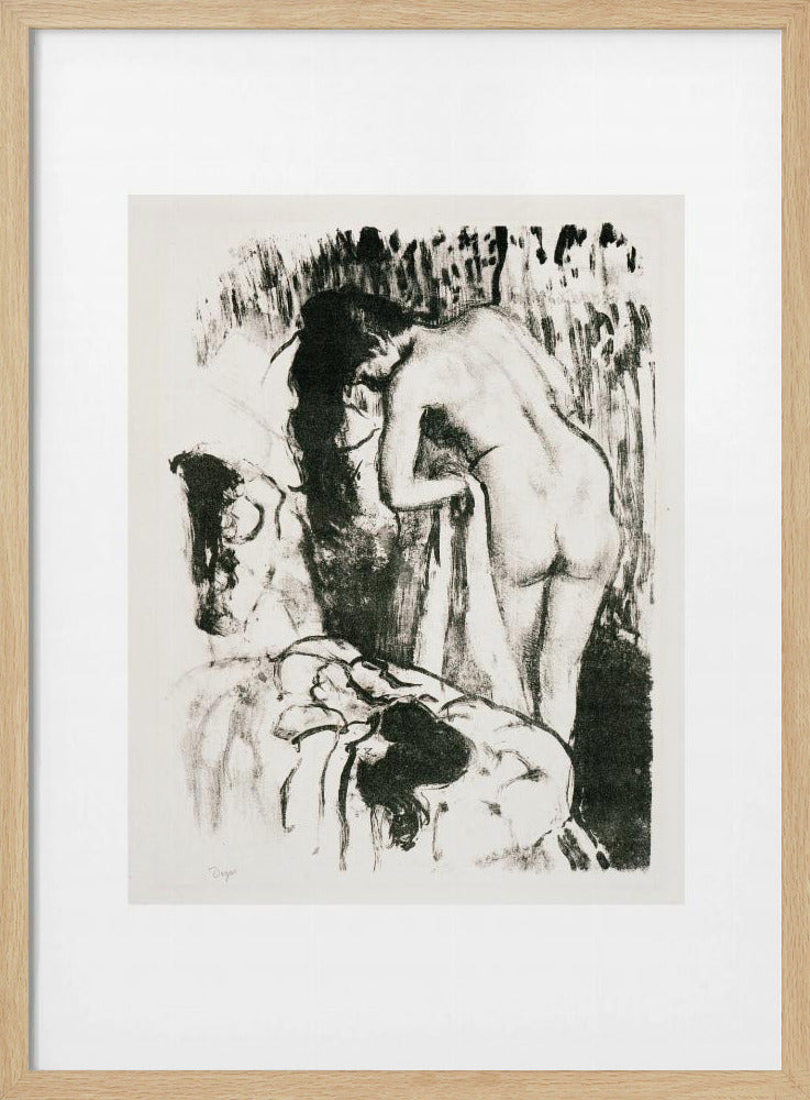 A framed black and white lithograph by Edgar Degas of a nude woman with long dark hair, viewed from the back as she leans over. The artwork has a sketchy, impressionistic style, capturing an intimate moment. Wall Art