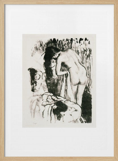 A framed black and white lithograph by Edgar Degas of a nude woman with long dark hair, viewed from the back as she leans over. The artwork has a sketchy, impressionistic style, capturing an intimate moment. Wall Art