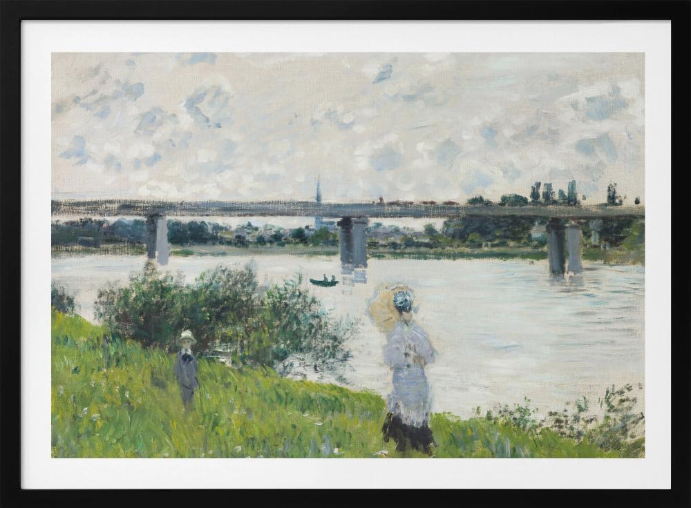 A scenic landscape art print by Claude Monet titled 'The Promenade With the Railroad Bridge, Argenteuil', depicting people on a promenade alongside a body of water with a railroad bridge in the background, characteristic of Impressionist style with soft colors and brushstrokes. Print