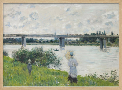 A scenic landscape art print by Claude Monet titled 'The Promenade With the Railroad Bridge, Argenteuil', depicting people on a promenade alongside a body of water with a railroad bridge in the background, characteristic of Impressionist style with soft colors and brushstrokes. Print