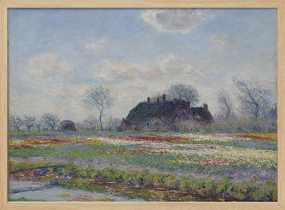 An Impressionist painting of a Dutch landscape featuring a field of colorful tulips in the foreground and a traditional farmhouse with a thatched roof in the background, under a cloudy blue sky. The artwork is displayed in a silver frame. Poster