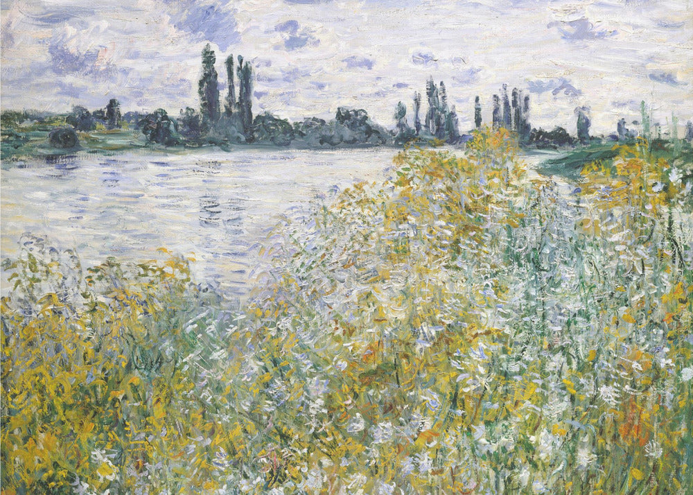 An impressionist landscape painting of a riverbank covered in yellow and white wildflowers. A calm river reflects the cloudy sky, and the opposite bank is lined with tall, dark poplar trees. The artwork is displayed in a silver frame. Artwork