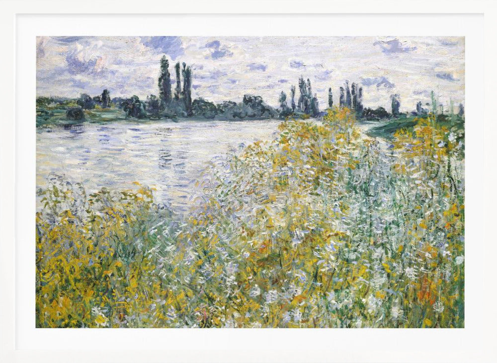 An impressionist landscape painting of a riverbank covered in yellow and white wildflowers. A calm river reflects the cloudy sky, and the opposite bank is lined with tall, dark poplar trees. The artwork is displayed in a silver frame. Artwork