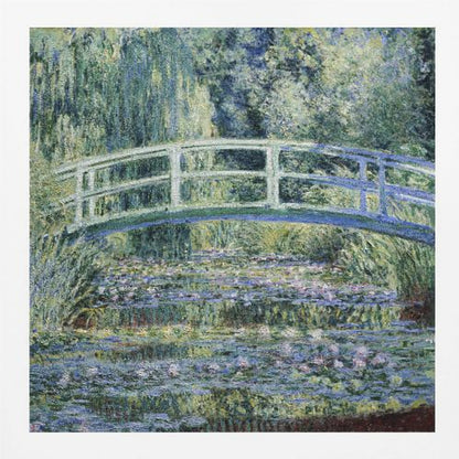 An Impressionist painting by Claude Monet, 'The Water Lily Pond', in a light wood frame. A pale green Japanese footbridge arches over a tranquil pond filled with pink and white water lilies, reflecting the lush green and blue foliage of weeping willows that surround it. Poster