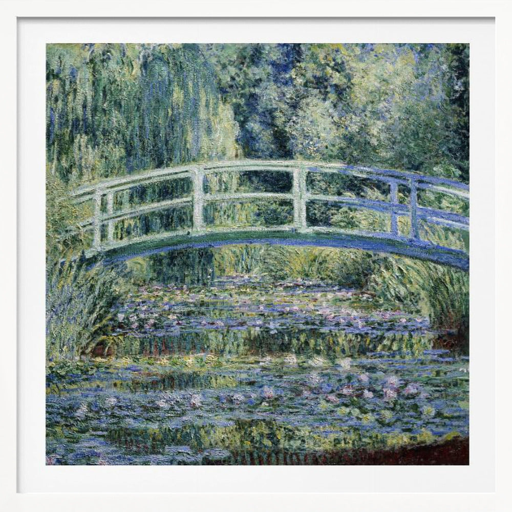 An Impressionist painting by Claude Monet, 'The Water Lily Pond', in a light wood frame. A pale green Japanese footbridge arches over a tranquil pond filled with pink and white water lilies, reflecting the lush green and blue foliage of weeping willows that surround it. Poster