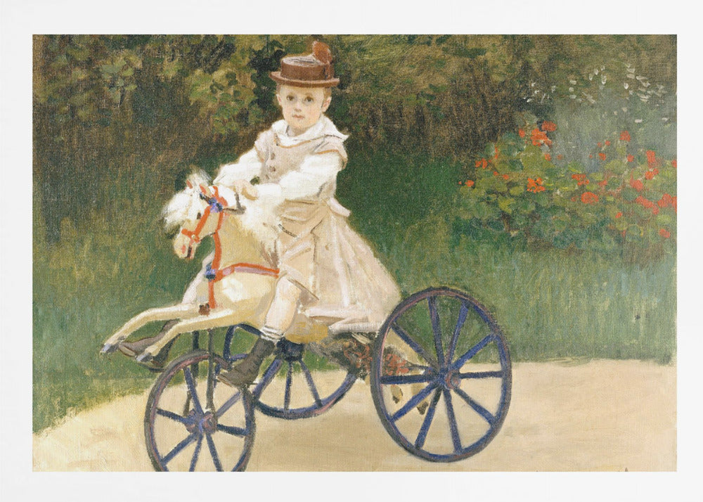 An Impressionist painting by Claude Monet depicting his son, Jean, riding a toy horse tricycle. The young boy wears a brown hat and a light-colored outfit, sitting on a white hobby horse with large blue wheels, set against a lush green garden background. Decor