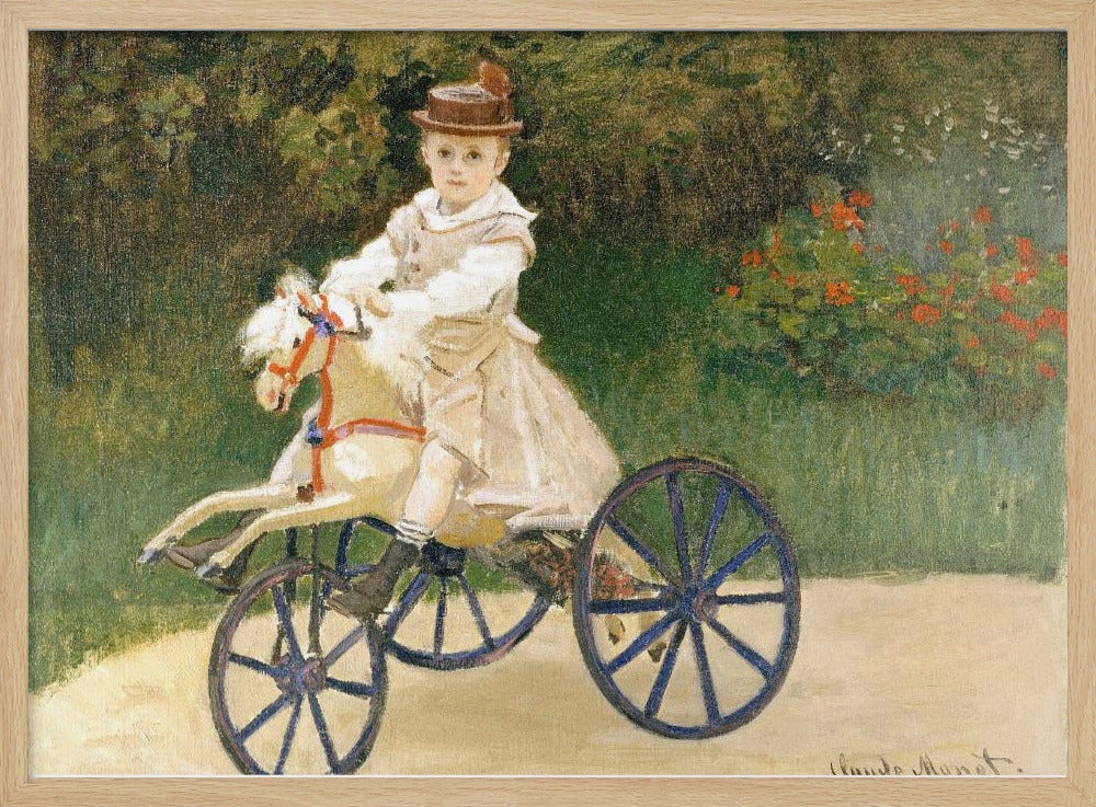 An Impressionist painting by Claude Monet depicting his son, Jean, riding a toy horse tricycle. The young boy wears a brown hat and a light-colored outfit, sitting on a white hobby horse with large blue wheels, set against a lush green garden background. Decor