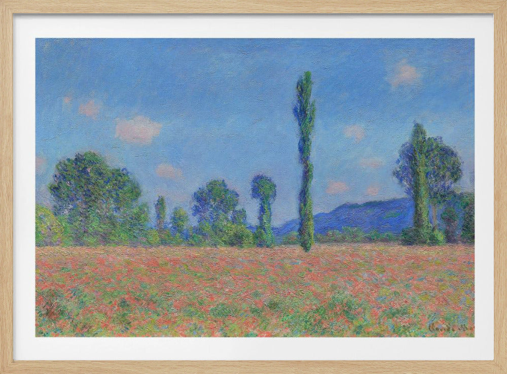 An impressionist painting of a vibrant landscape, 'Poppy Field' by Claude Monet, in a silver frame. It depicts a field of red flowers in the foreground, with a line of green trees and tall poplars against a backdrop of distant blue hills and a bright blue sky with soft clouds. Print