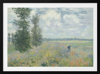 An impressionist painting by Claude Monet titled 'Poppy Field near Vétheuil', depicting a vast field of green grass dotted with red, yellow, and purple wildflowers. A figure in a white bonnet stands in the field to the right. Tall green trees are on the left, under a blue sky with fluffy white clouds. The entire scene is presented within a modern silver frame. Wall Art