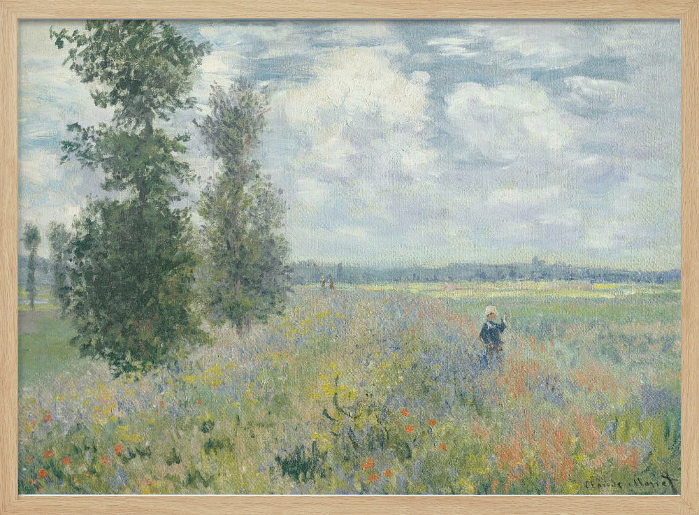 An impressionist painting by Claude Monet titled 'Poppy Field near Vétheuil', depicting a vast field of green grass dotted with red, yellow, and purple wildflowers. A figure in a white bonnet stands in the field to the right. Tall green trees are on the left, under a blue sky with fluffy white clouds. The entire scene is presented within a modern silver frame. Wall Art