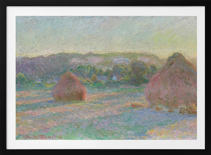 An Impressionist painting by Claude Monet depicting two large, reddish haystacks in a field of green and purple hues during sunrise, with a line of distant trees under a pale yellow sky, all within a silver frame. Poster