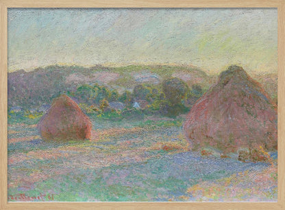An Impressionist painting by Claude Monet depicting two large, reddish haystacks in a field of green and purple hues during sunrise, with a line of distant trees under a pale yellow sky, all within a silver frame. Poster