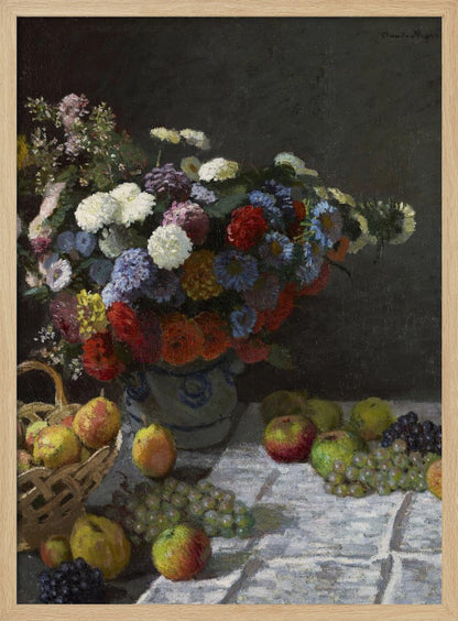 A classic still life painting by Claude Monet depicting a vibrant, multicolored bouquet of flowers in a ceramic vase. Scattered around the vase on a white tablecloth are various fruits, including apples, pears in a basket, and bunches of grapes, all set against a dark, moody background. Poster