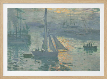 A framed print of Claude Monet's famous Impressionist painting, 'Impression, Sunrise'. The artwork depicts a misty harbor scene in muted blue and grey tones. A bright orange sun is visible through the haze, its light reflecting on the water's surface. Several boats, including a prominent sailboat in the foreground, are silhouetted against the dawn light. Print