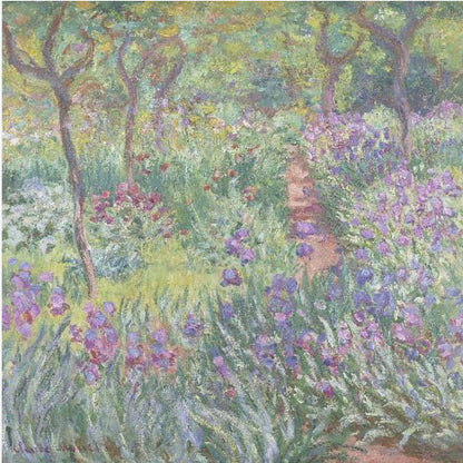An impressionist painting by Claude Monet, 'The Artist's Garden at Giverny,' set in a light wood frame. The artwork depicts a lush, vibrant garden with a path winding through it. The foreground is dominated by purple irises and tall green leaves, while the background features trees and a mix of colorful flowers in shades of red, yellow, and white, all rendered with visible, textured brushstrokes. Print