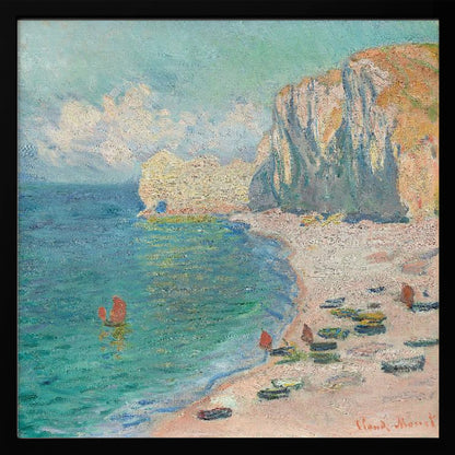An impressionist painting by Claude Monet depicting the beach at Étretat, France, enclosed in a light wood frame. The artwork shows tall, light-colored cliffs on the right, a sandy beach with small boats, and vibrant turquoise water with a few red-sailed boats. The sky is partly cloudy. Decor
