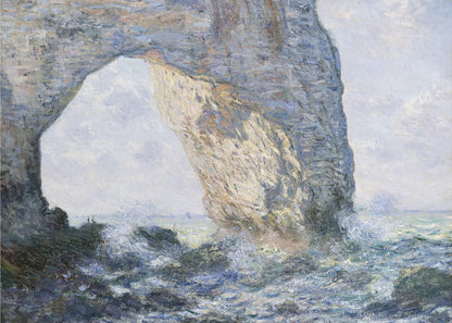 An impressionist painting by Claude Monet of the Manneporte rock arch at Étretat, France. Sunlight illuminates the massive stone arch as turbulent blue and white waves crash against the rocky shoreline below. The artwork is displayed in a silver frame. Decor