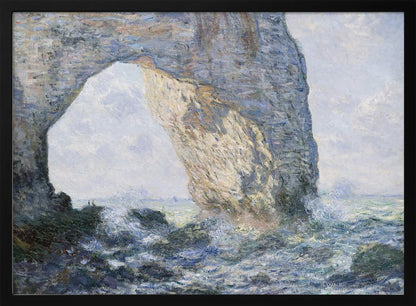 An impressionist painting by Claude Monet of the Manneporte rock arch at Étretat, France. Sunlight illuminates the massive stone arch as turbulent blue and white waves crash against the rocky shoreline below. The artwork is displayed in a silver frame. Decor