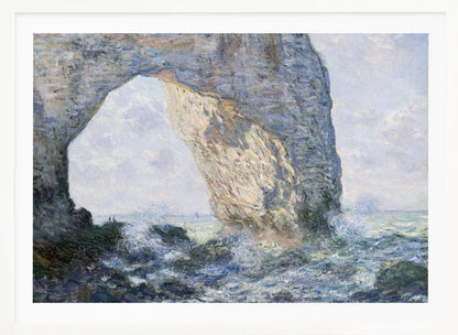 An impressionist painting by Claude Monet of the Manneporte rock arch at Étretat, France. Sunlight illuminates the massive stone arch as turbulent blue and white waves crash against the rocky shoreline below. The artwork is displayed in a silver frame. Decor