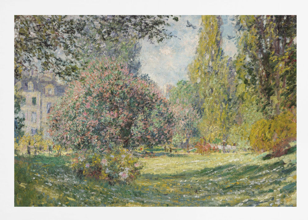 An impressionist painting by Claude Monet titled 'The Parc Monceau' displayed in a silver frame. The scene depicts a sunlit park with lush green grass, a large pink-flowering bush, and tall, leafy trees under a pale blue sky. Decor