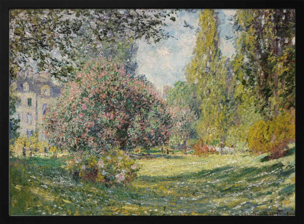 An impressionist painting by Claude Monet titled 'The Parc Monceau' displayed in a silver frame. The scene depicts a sunlit park with lush green grass, a large pink-flowering bush, and tall, leafy trees under a pale blue sky. Decor