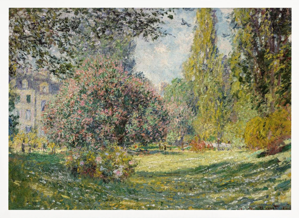An impressionist painting by Claude Monet titled 'The Parc Monceau' displayed in a silver frame. The scene depicts a sunlit park with lush green grass, a large pink-flowering bush, and tall, leafy trees under a pale blue sky. Decor