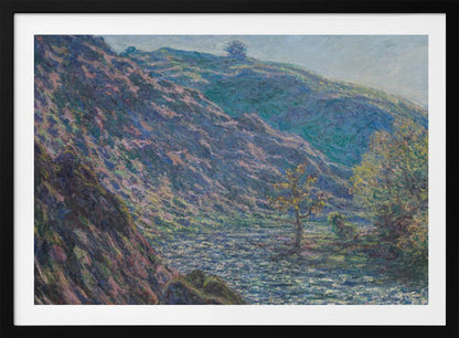 A framed Impressionist painting depicting a river valley. A steep hillside with purple and blue tones dominates the left, while a sun-dappled river flows below. In the distance, gentle green and blue hills rise against a pale sky. Artwork