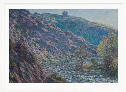 A framed Impressionist painting depicting a river valley. A steep hillside with purple and blue tones dominates the left, while a sun-dappled river flows below. In the distance, gentle green and blue hills rise against a pale sky. Artwork