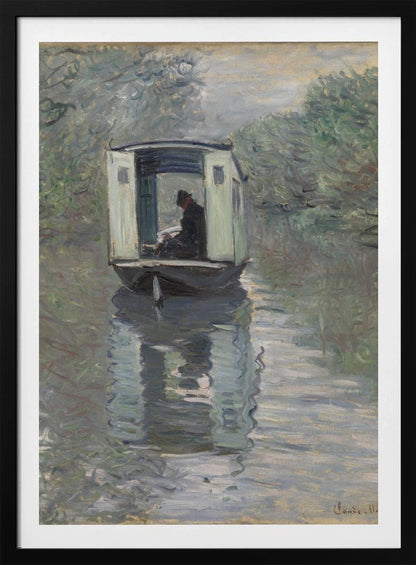 An Impressionist painting by Claude Monet titled 'The Studio Boat,' depicting a figure in a hat and dark coat sitting inside a small, white-paneled boat on a calm, grey-green river. The scene is enveloped in a soft, hazy light, with blurry trees lining the banks and a strong, rippling reflection of the boat in the water. Artwork