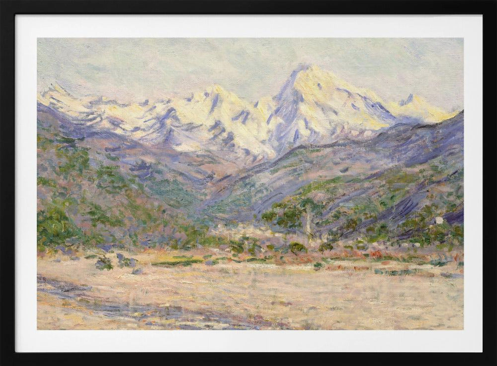 An impressionistic painting of a vast mountain range. The snow-covered peaks are bathed in pale yellow sunlight, while the lower slopes are cast in shades of purple and blue. A wide, beige valley with patches of green foliage sits in the foreground, all rendered with visible, textured brushstrokes and displayed in a silver frame. Print