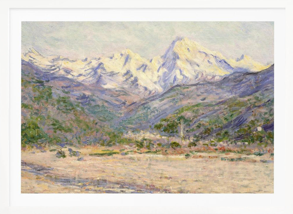 An impressionistic painting of a vast mountain range. The snow-covered peaks are bathed in pale yellow sunlight, while the lower slopes are cast in shades of purple and blue. A wide, beige valley with patches of green foliage sits in the foreground, all rendered with visible, textured brushstrokes and displayed in a silver frame. Print