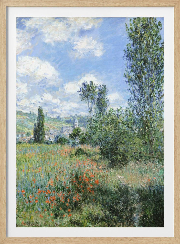 An impressionist painting depicting a vibrant green field filled with red poppies under a bright blue sky with fluffy white clouds. Tall green trees stand on the right, and in the distance, a small village with a church steeple is nestled in the rolling hills. Decor