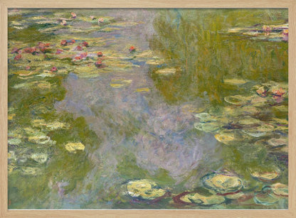 An impressionist painting of a water lily pond by Monet, featuring pink and red water lilies floating amongst green pads on the water's surface, which reflects the surrounding greenery and sky in shades of green, blue, and violet. The painting is displayed in a modern silver frame. Wall Art