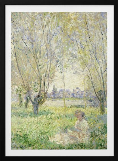 An Impressionist painting, 'Springtime' by Claude Monet, showing a woman in a hat sitting in a sunlit green field. Slender trees with light green foliage frame a view of a village across a river, evoking a peaceful spring day. The artwork is presented in a simple black frame. Artwork