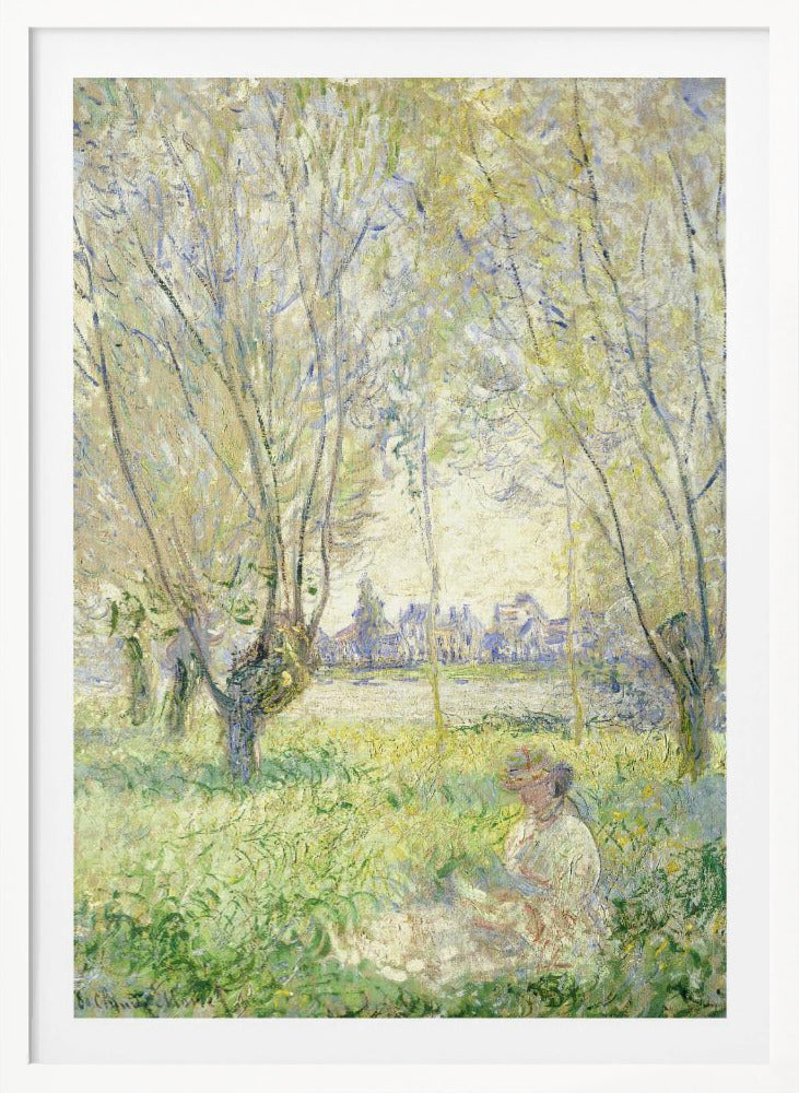 An Impressionist painting, 'Springtime' by Claude Monet, showing a woman in a hat sitting in a sunlit green field. Slender trees with light green foliage frame a view of a village across a river, evoking a peaceful spring day. The artwork is presented in a simple black frame. Artwork